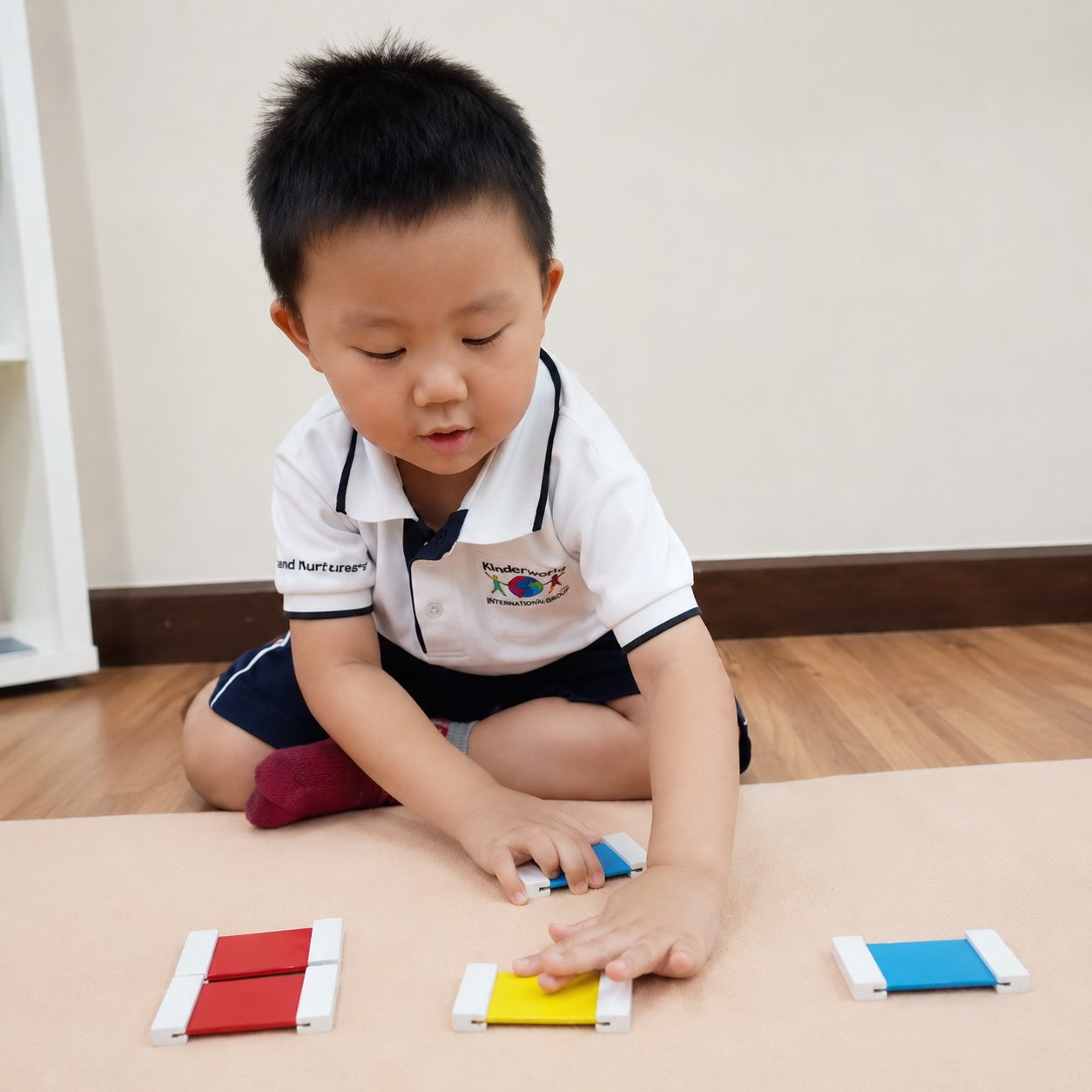 A toddler matching Montessori colour tablets