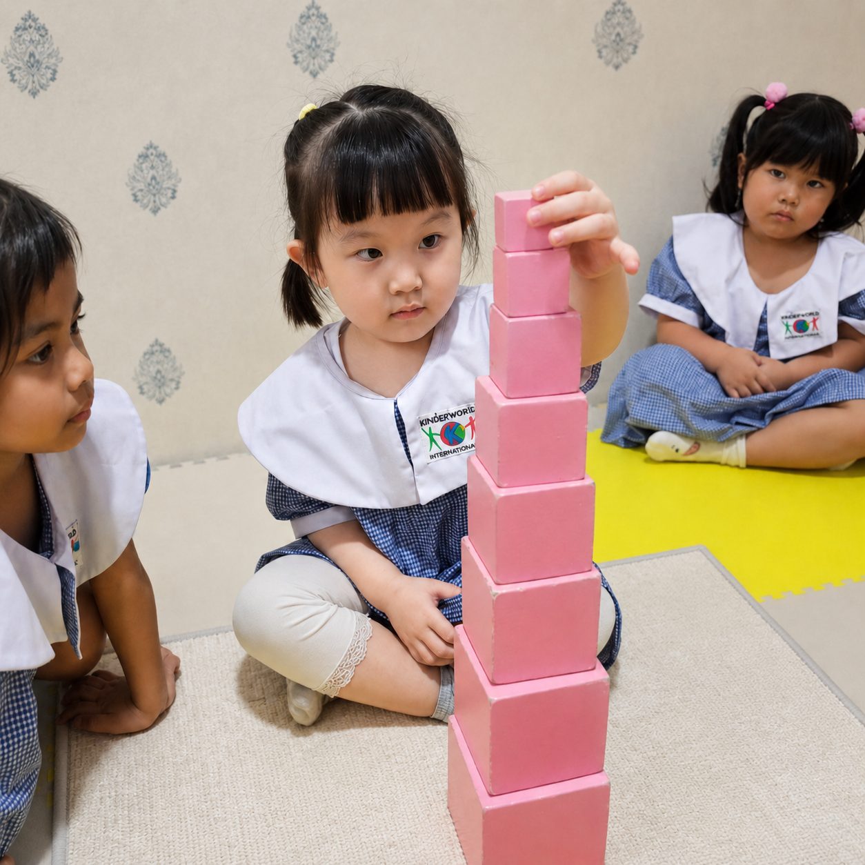 A child building the Montessori Pink Tower
